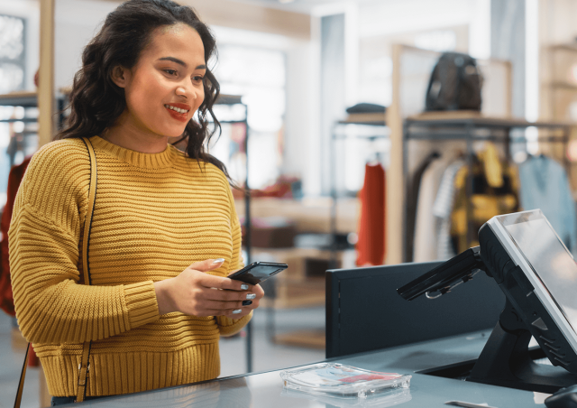 Woman paying at clothing store